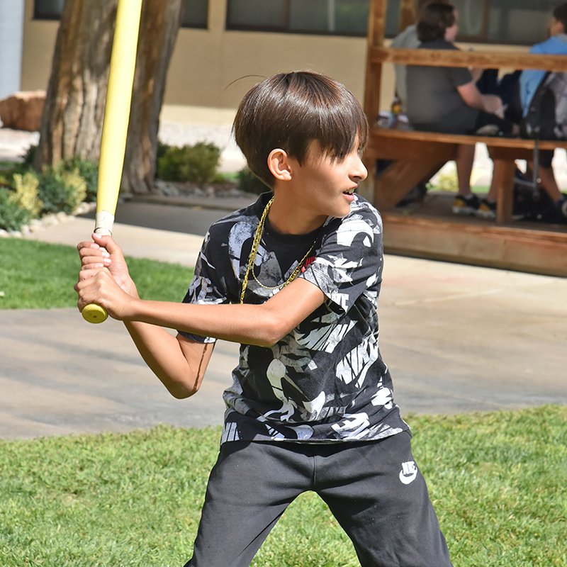 Student playing baseball during lunch