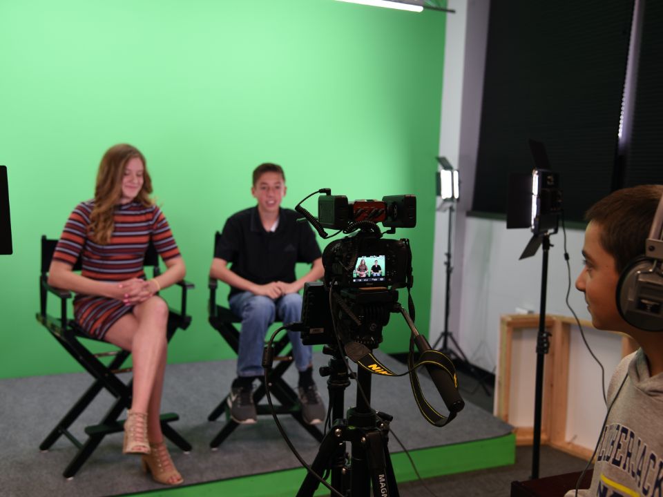 Students filming a news segment
