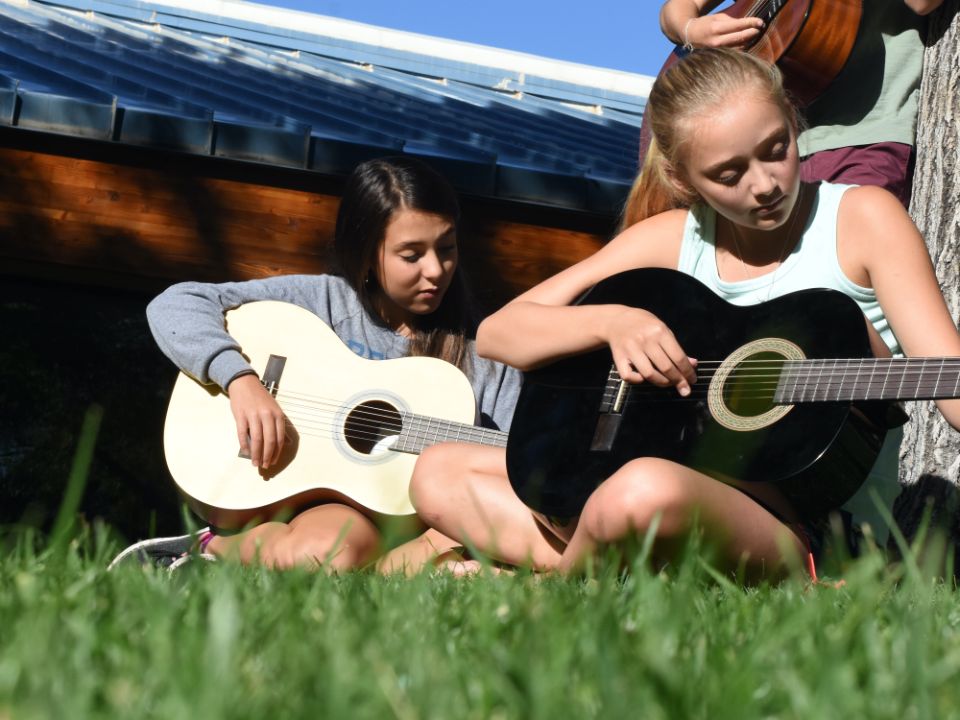 Students playing guitar on the Quad