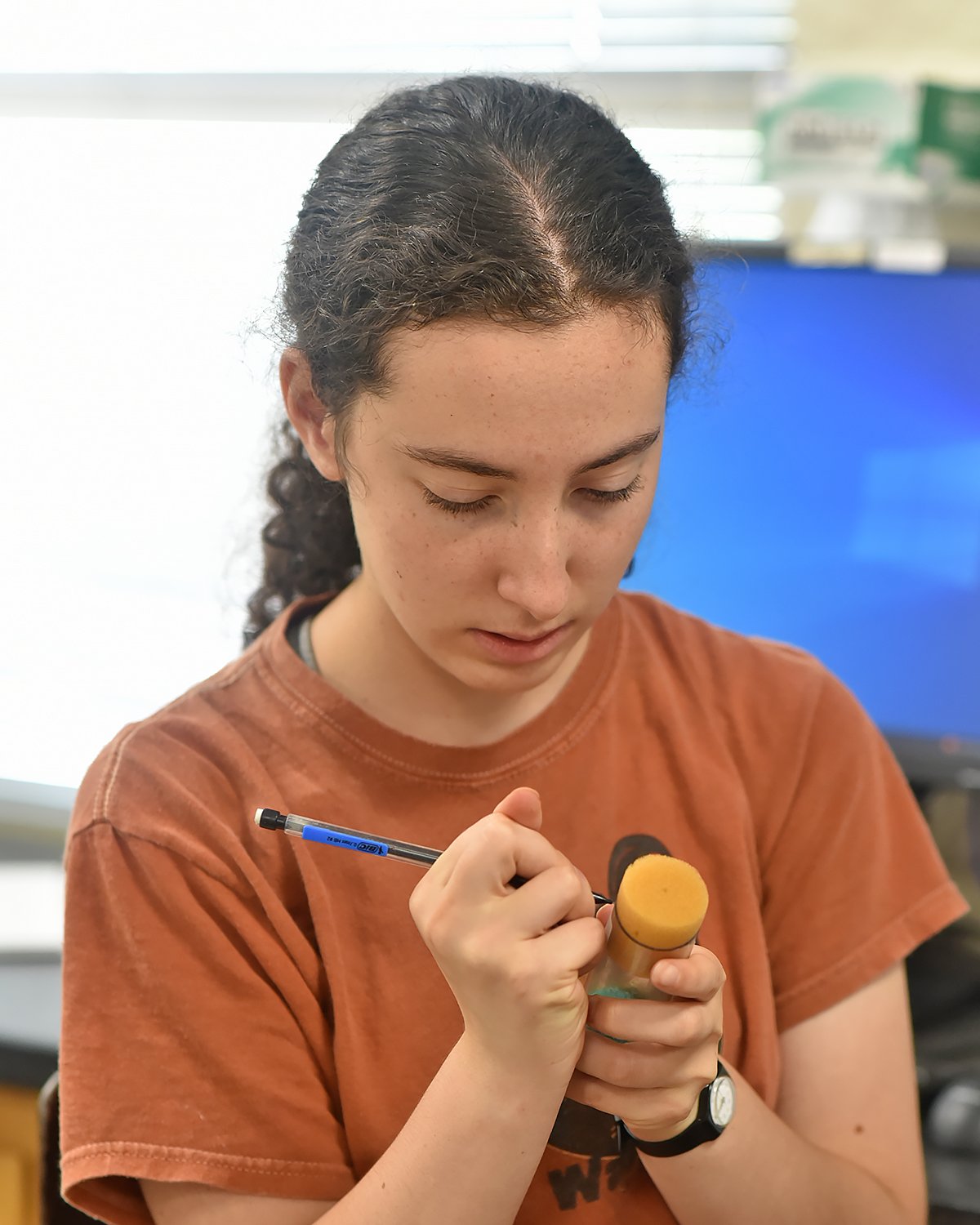 Student labeling vial in classroom