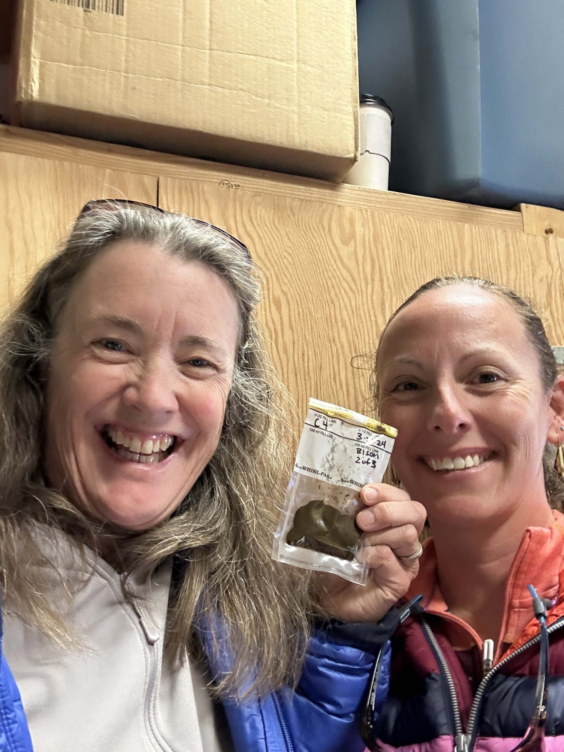 Prep science teacher Helen Haskell and fellowship teacher display bison scat sample