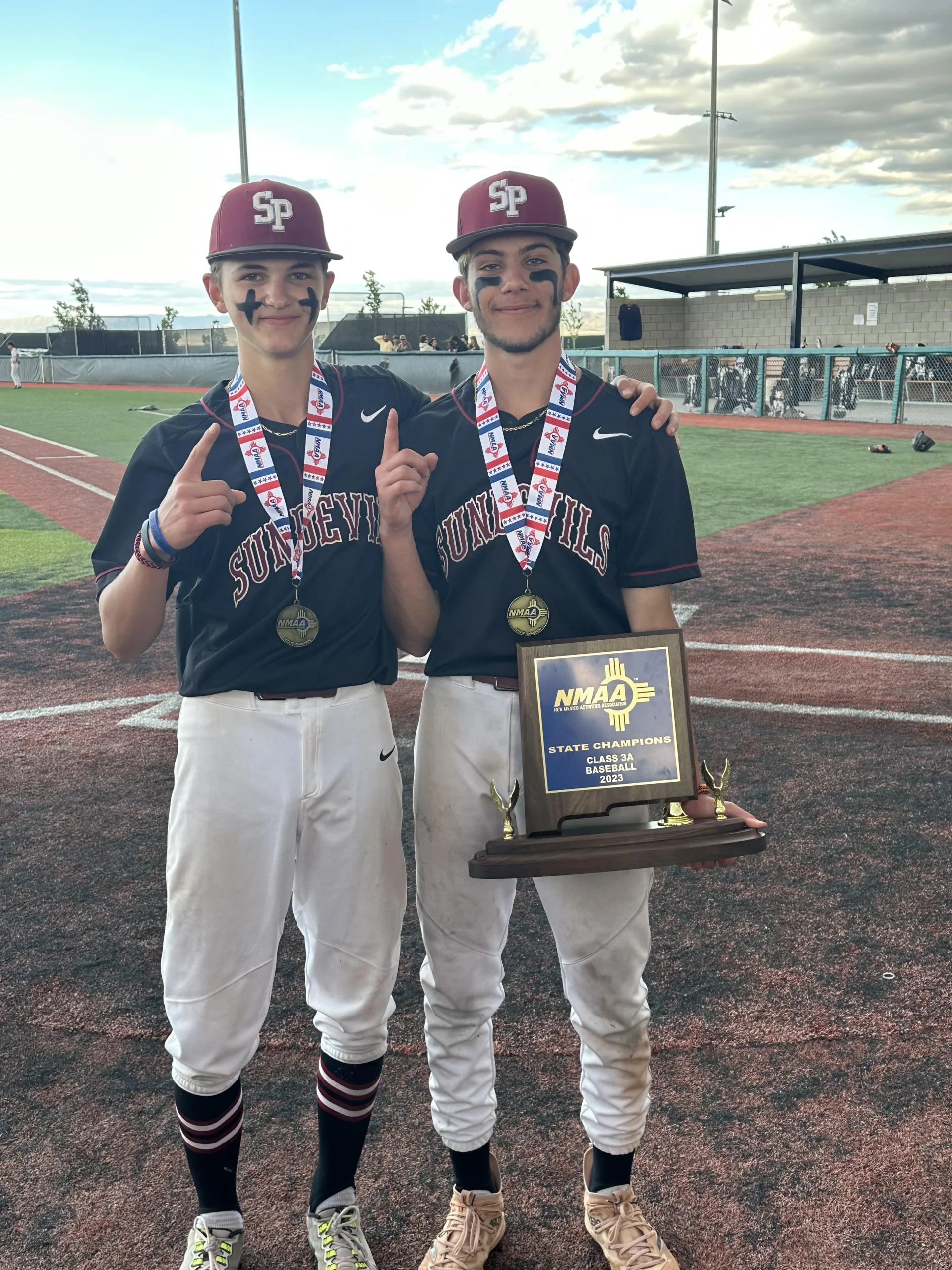 Logan Lemons '27 and his brother Lucas Lemons '23 celebrate winning a state championship for Sandia Prep 