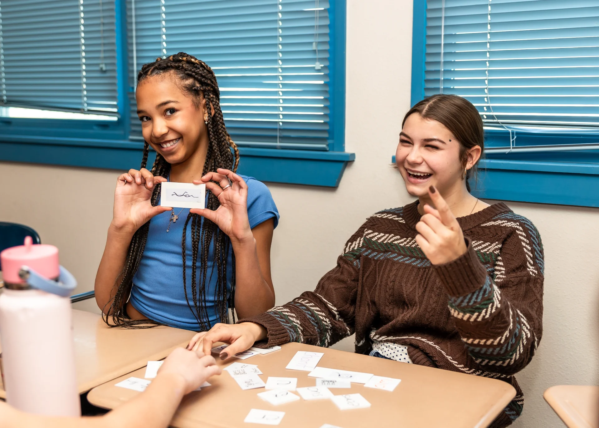 Girls smiling during activity in classroom 