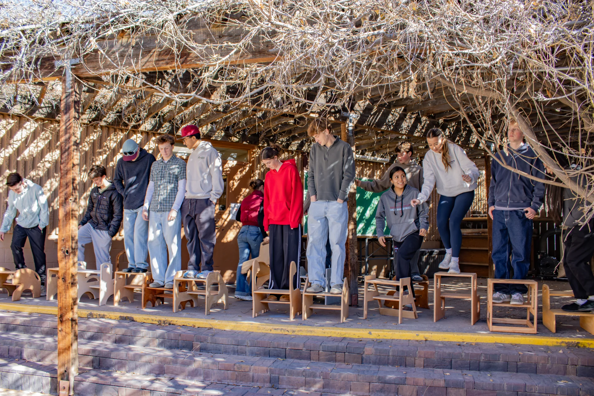 Students standing on step stools they created