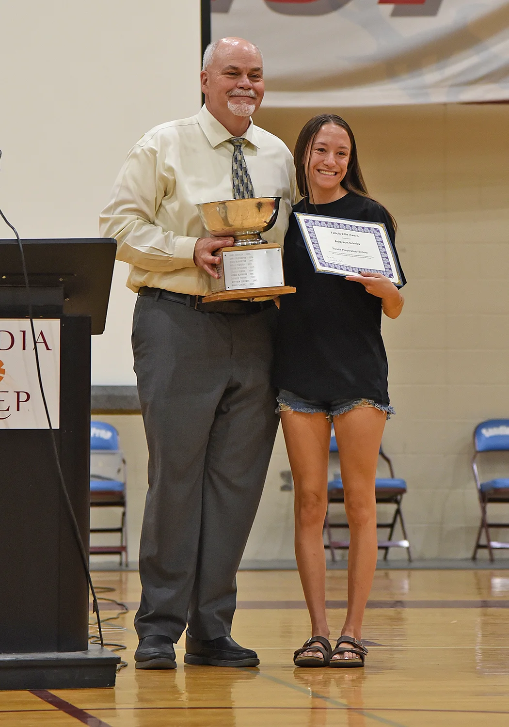Student receiving award from head of school