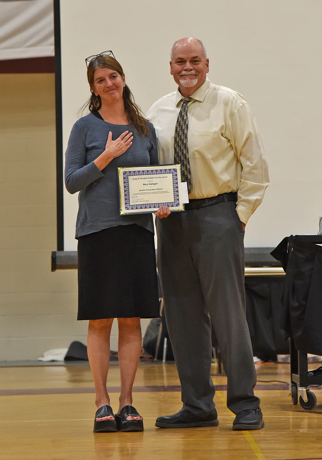 Teacher receiving award from head of school