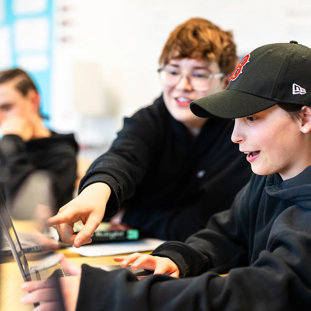 students looking at laptop screen together
