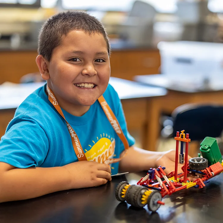 camper smiling with project
