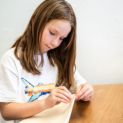 Camper sewing a costume