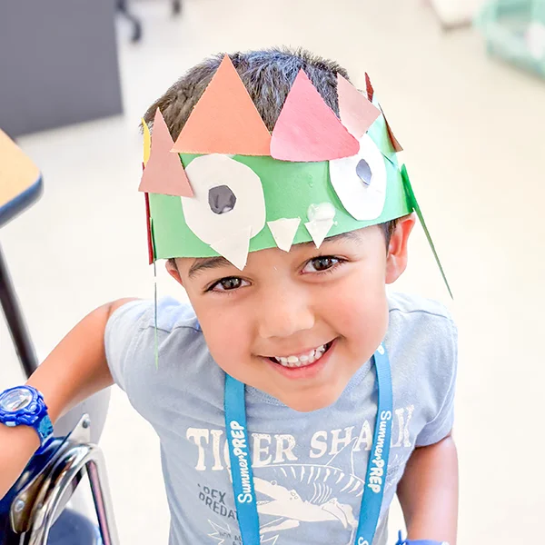 camper wearing dinosaur hat 