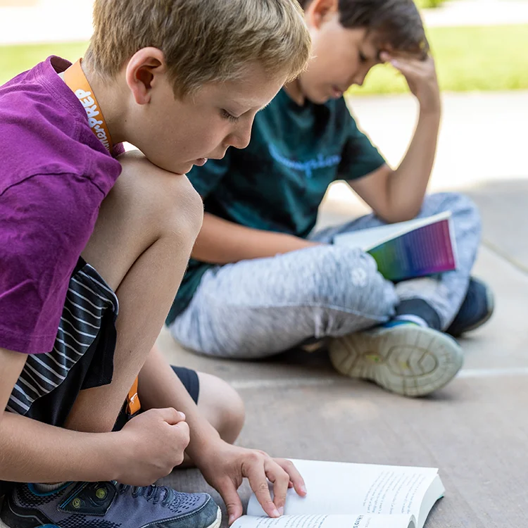 campers reading books outside