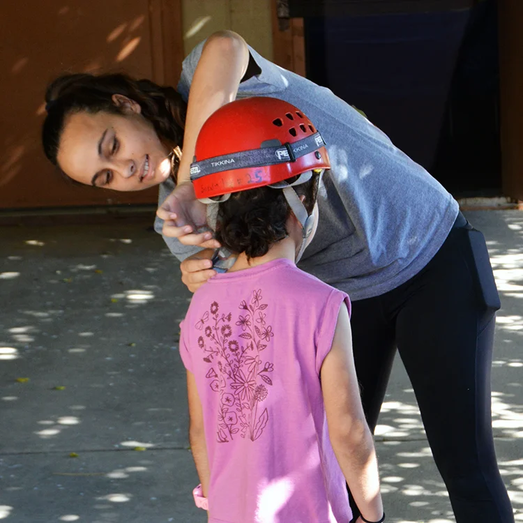 camper getting fitted for a helmet