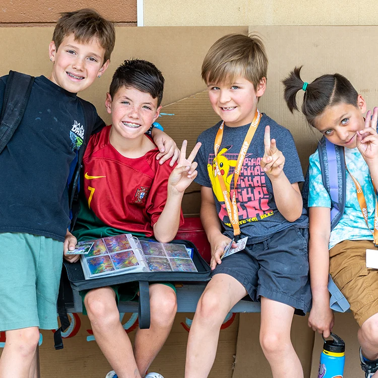 Four campers with pokemon cards