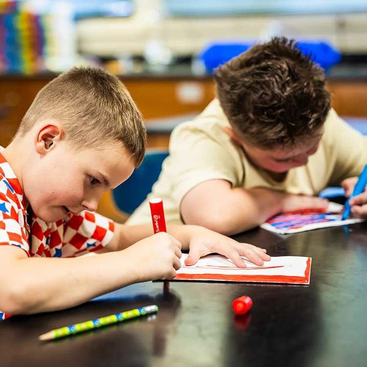 campers working on paper puzzles 
