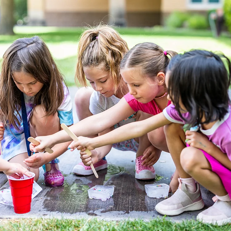 Four campers doing an experiment