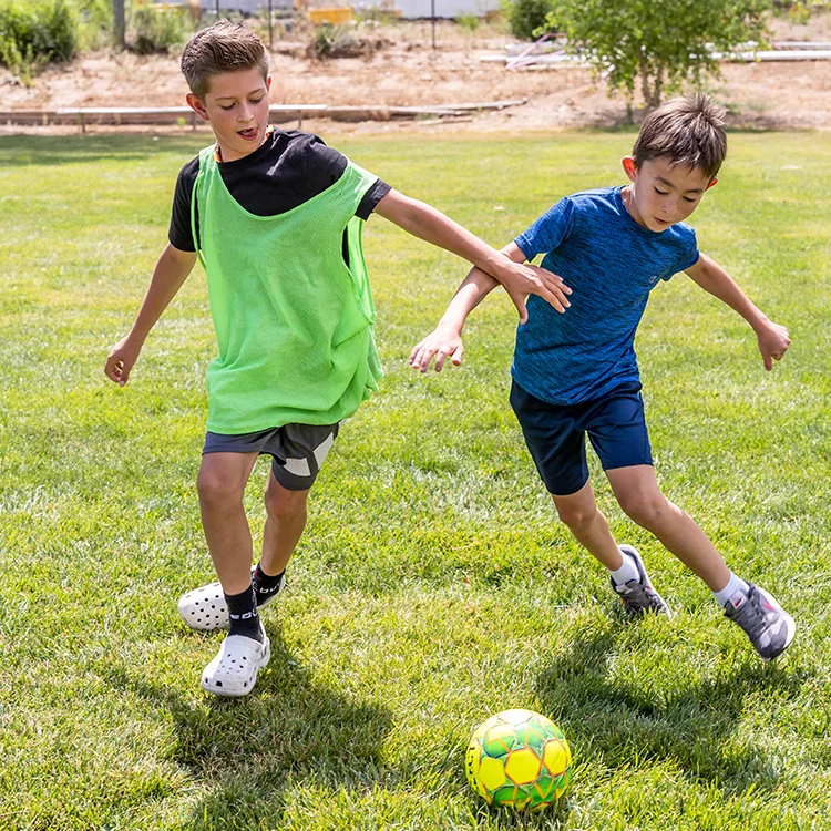 two campers playing soccer