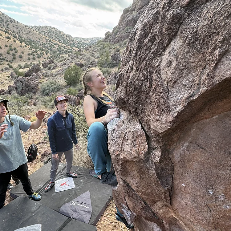 student rock climbing