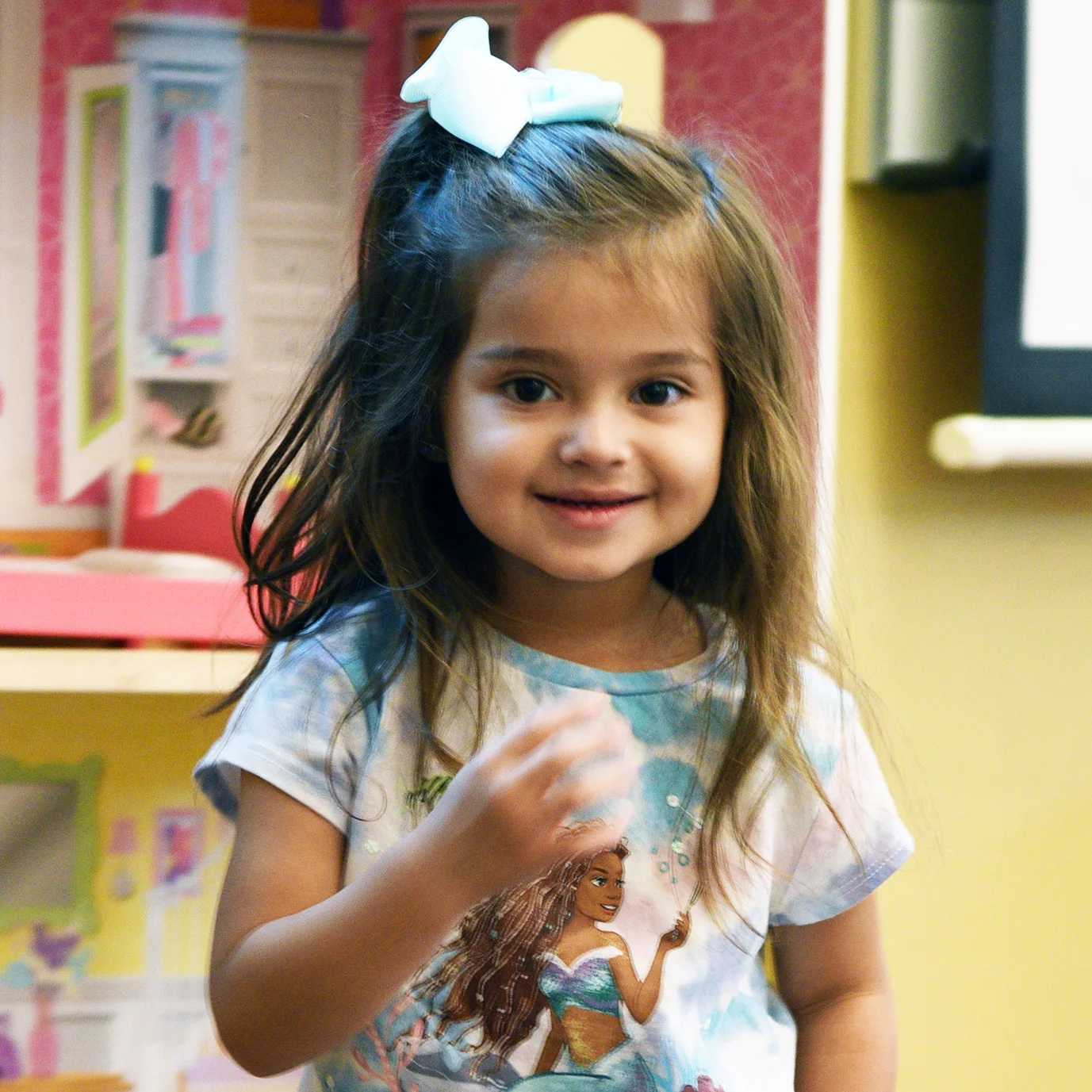 Tiny Tot camper smiling at camera