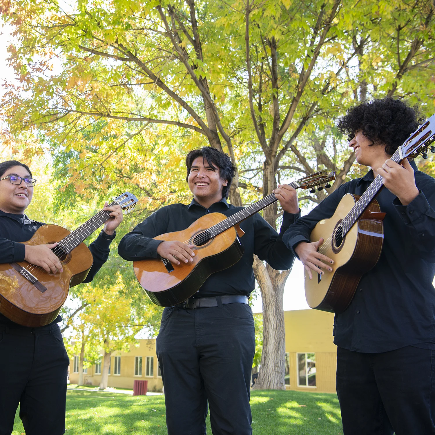 Students playing guitar on the Quad