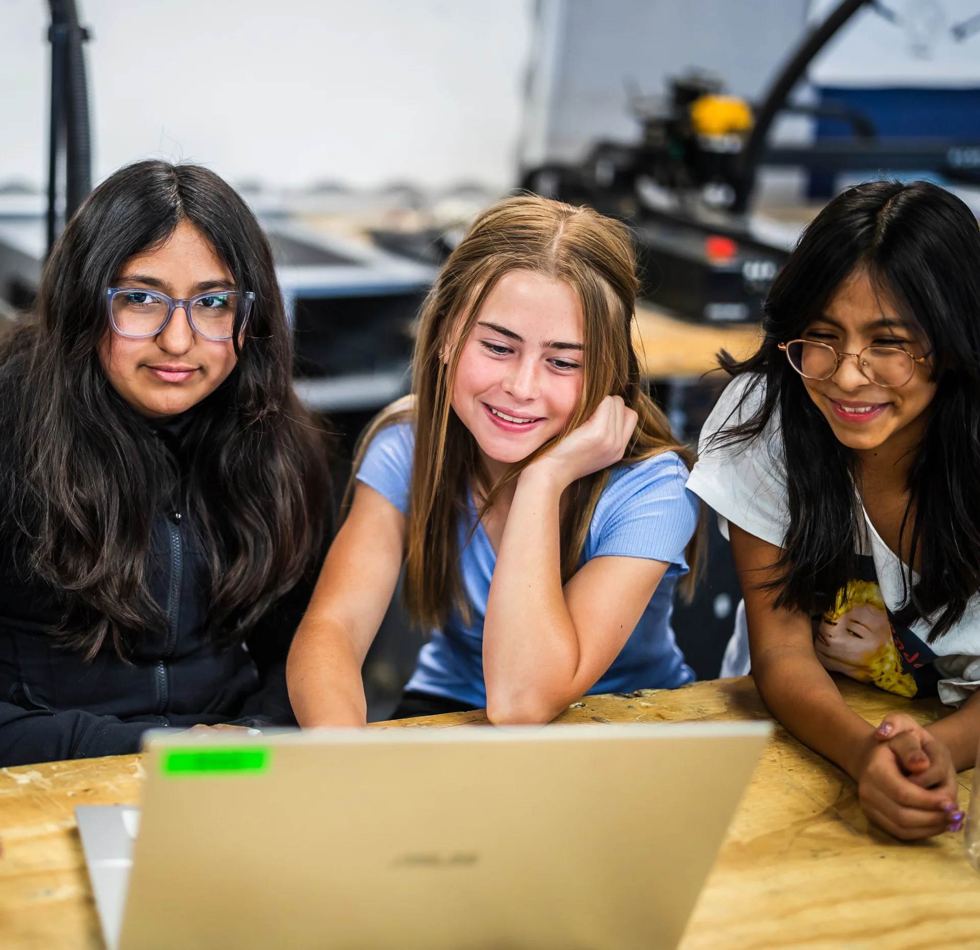 Three students at a laptop