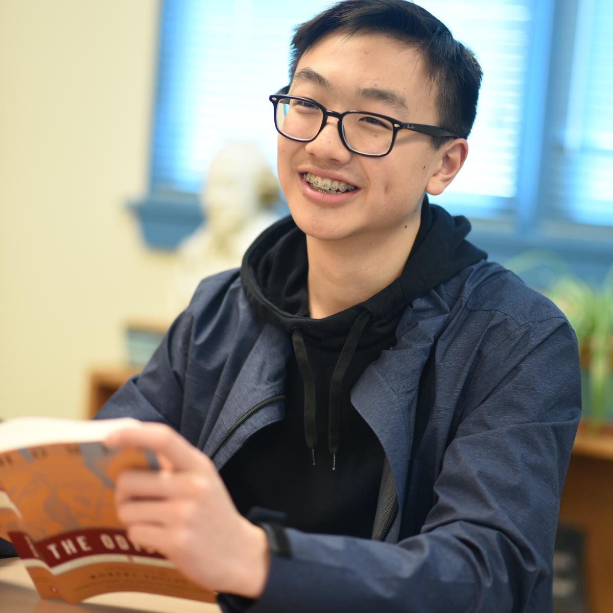 Student smiling with book